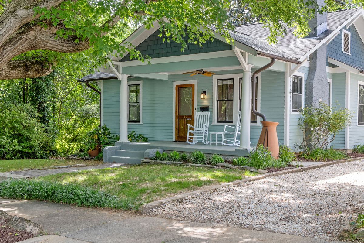 Craftsman bungalow with a covered front porch and rocking chairs